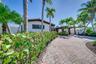 Waterfront Home | Curved Paver Driveway | Lush Tropical Gardens | South Florida