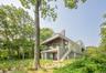 Back of property featuring stairs, ceiling fan, and a balcony