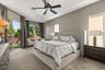 Primary bedroom with tray ceilings and updated fan