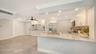 The newly remodeled kitchen features a 9' breakfast bar and granite countertops.