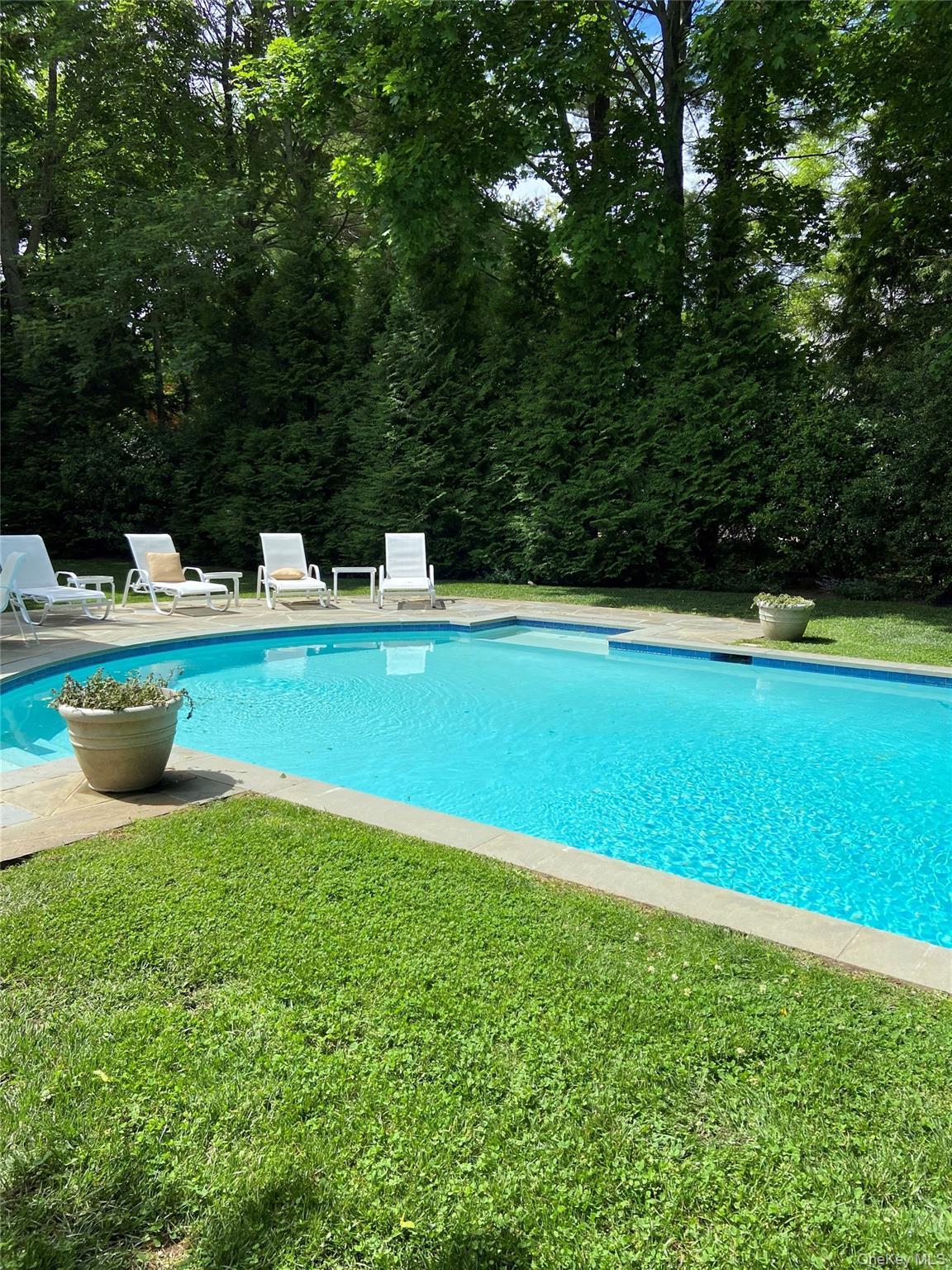 View of pool with a lawn