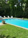 View of pool with a lawn