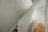 Wood-finish flooring with white baseboards