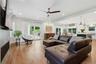 Open-concept living space featuring hardwood flooring, and floor-to-ceiling windows with natural light