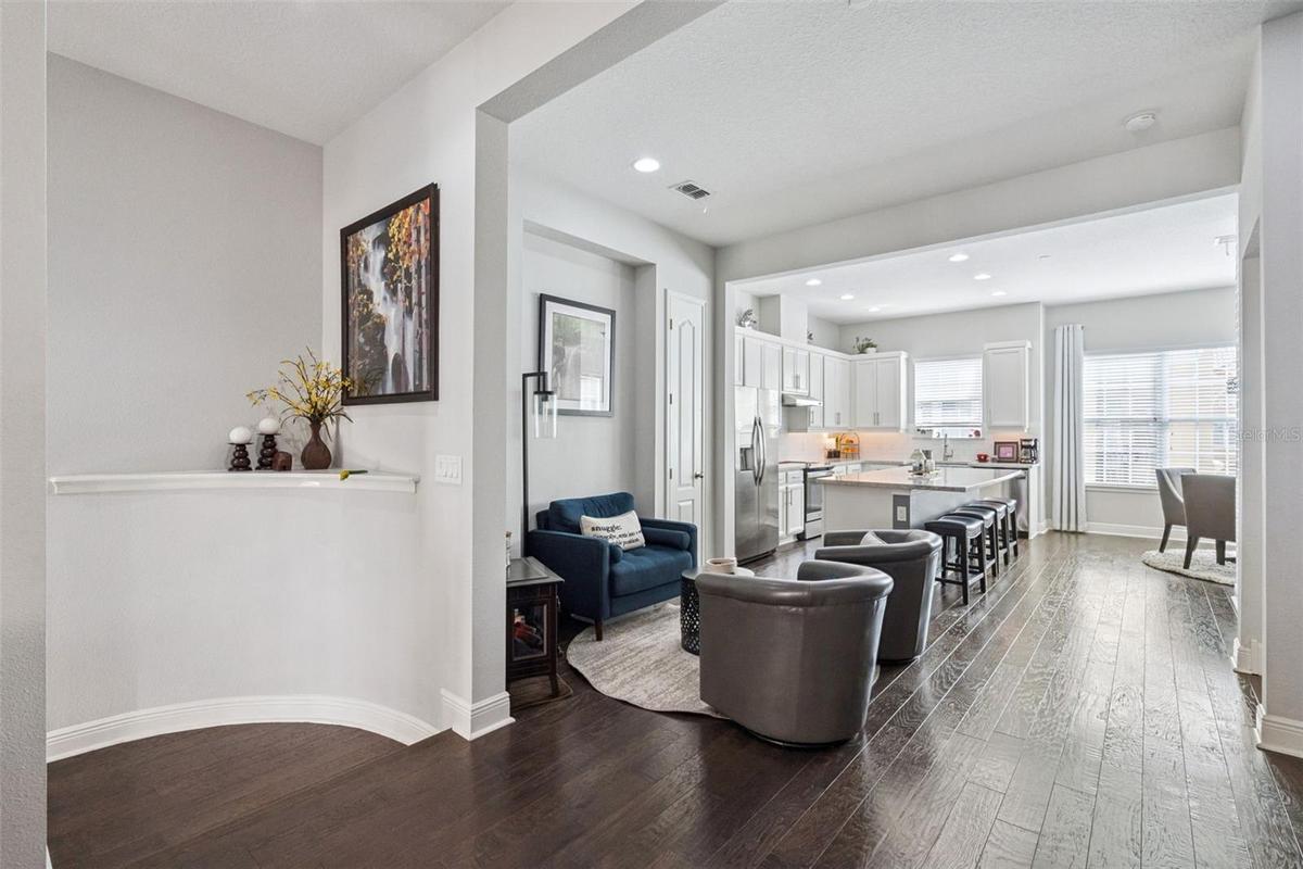 Entryway, sitting area, and kitchen