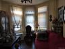 Living area featuring radiator, wood finished floors, and a chandelier