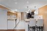 This bright and airy lower level kitchen features butcher block countertops and stainless steel appliances.