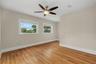 The bedroom offers hardwood floors, abundant natural light, and plenty of room to create a comfortable retreat.