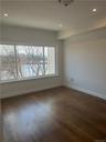 This is the huge, Master Bedroom Suite, featuring sumptuous hardwood flooring and large picture window with a scenic view of the bay and Long Island S