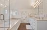 Bathroom with a garden tub, a shower stall, vanity, wood finished floors, and wallpapered walls
