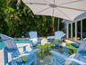 Adirondak seating featuring a large patio umbrella for shade