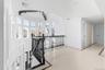 Corridor featuring an upstairs landing, ornamental molding, and inlaid floor details