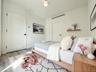 Bedroom with wood finished floors and baseboards