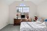 Bedroom with lofted ceiling and light colored carpet