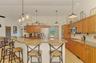 Granite counters and tile backsplash and upgraded lighting in the kitchen
