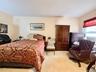 Large primary bedroom, carpeted. There are 2 closets and a large window, an extra closet in the hallway near this bedroom.