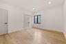 Light wood-finish flooring complements the neutral wall tones in this room