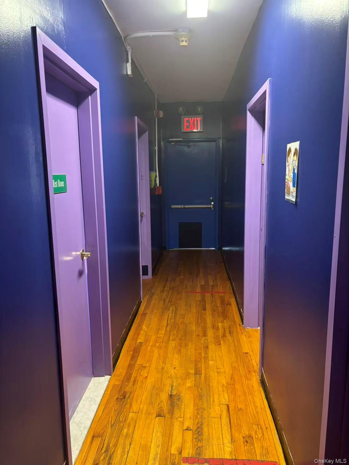 Corridor featuring light wood-style floors and elevator