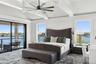 Bedroom featuring access to outside, a water view, and ceiling fan