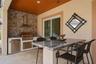 Outdoor Kitchen and outdoor seating with built in speakers