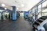 The fitness center features walls of glass that fill the space with natural light and inspiring views.
