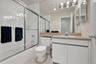Full bath with visible vents, toilet, shower / bath combination with glass door, tile patterned floors, and vanity