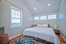 Waterfront window providing natural light, vaulted ceiling with recessed lighting, shiplap ceiling finish, and hardwood flooring