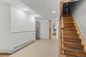 Stairs featuring a baseboard heating unit and recessed lighting