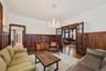 Living room with a wainscoted wall, a chandelier, french doors, and hardwood / wood-style floors