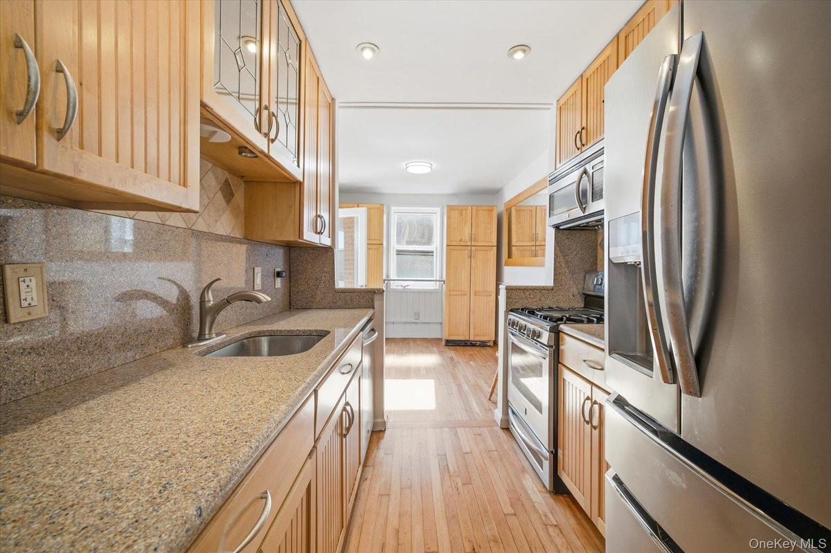 Kitchen with hardwood floors and stainless steel appliances