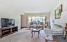 Carpeted living area featuring baseboards