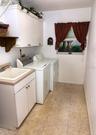 Tiled dedicated laundry room with sink