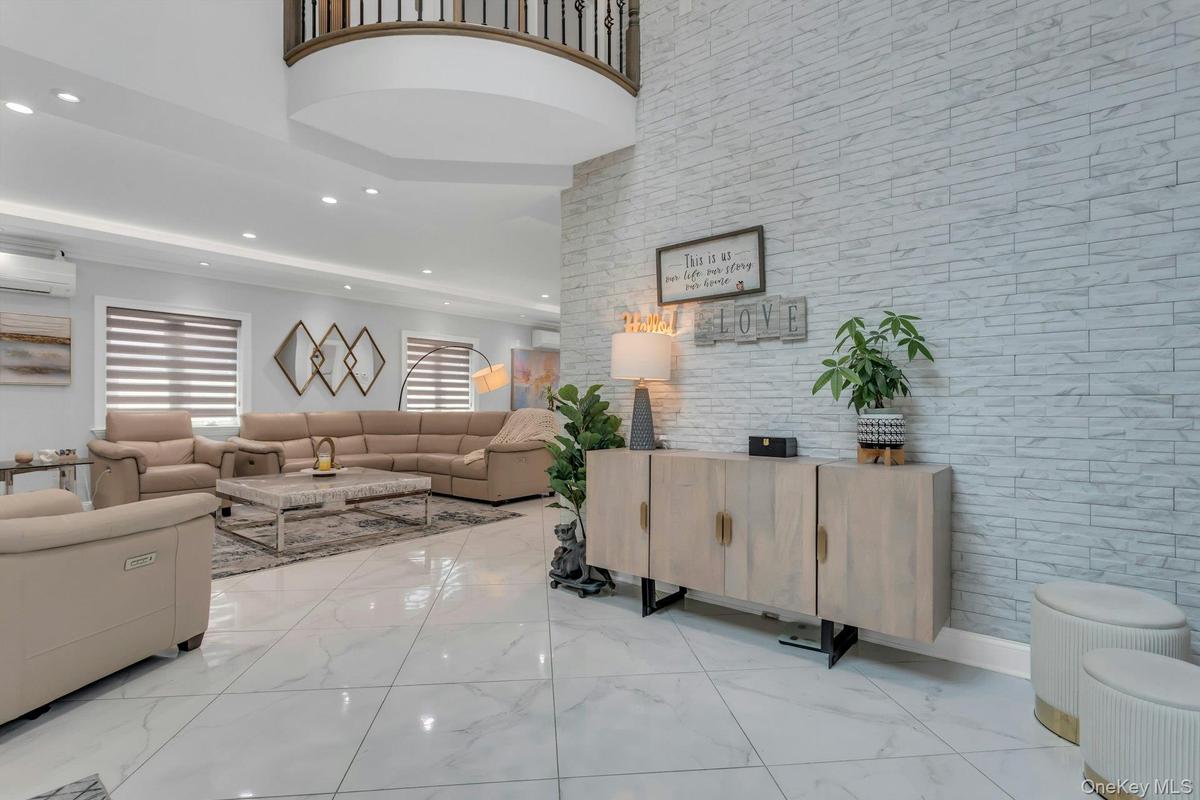 Stunning ceiling fixtures throughout with a white porcelain veined tile installed on an angle, magnifiying the length of each beautiful room
