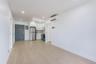 Unfurnished living room featuring recessed lighting, an AC wall unit, and electric panel