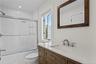 Second floor bathroom with shower/tub combo.