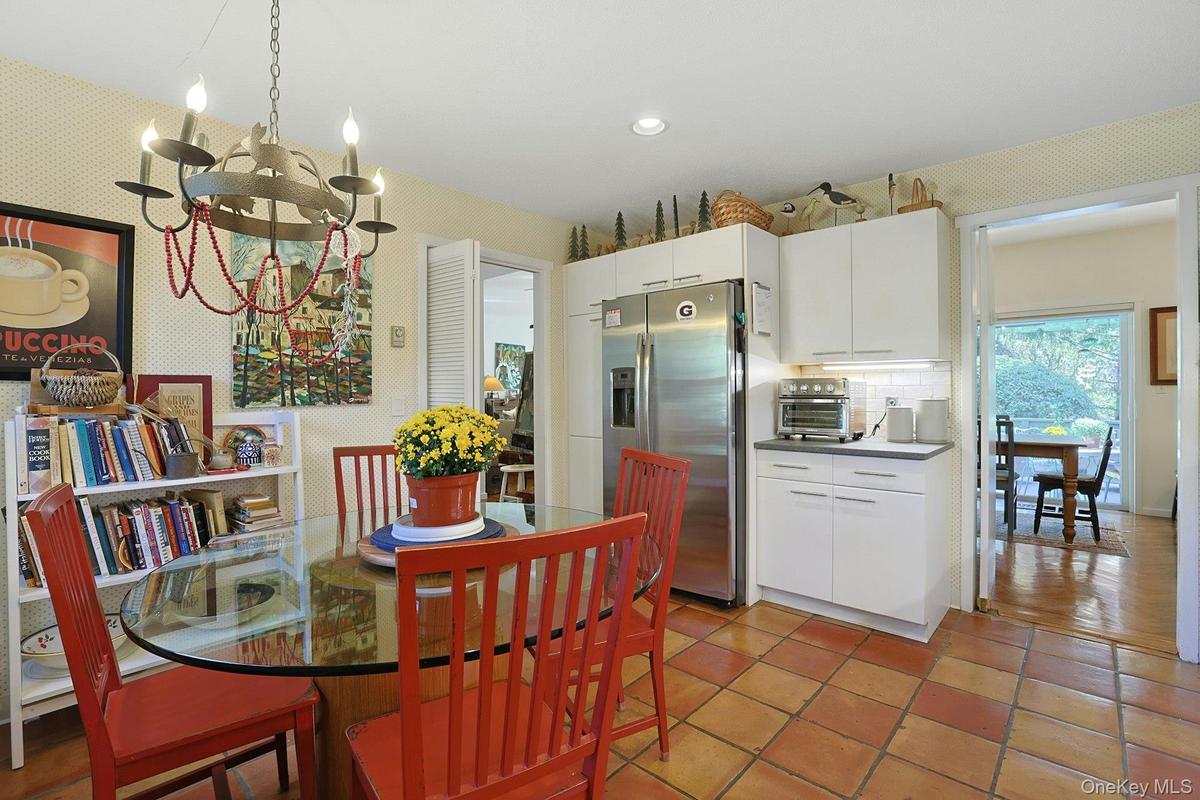 Kitchen Dining space featuring a chandelier, terracotta tile flooring, and recessed lighting