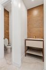Bathroom with toilet and light tile patterned floors