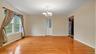 Spare room featuring an inviting chandelier, baseboards, visible vents, and light wood-style floors