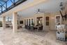 Oversized covered lanai designed for year-round outdoor living, dining and entertaining with peaceful water front views.