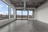 Empty room featuring finished concrete flooring and a view of skyline