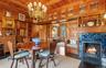 Dining space featuring a chandelier, wood ceiling, wood walls, and hardwood / wood-style flooring