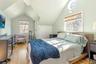 Bedroom featuring lofted ceiling, a closet, and light wood-style flooring
