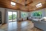 Huge Den with sliders to 2nd side deck overlooking natural 1/2 acre.  skylights & natural wood flooring