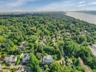 Aerial view of property and surrounding area featuring a nearby body of water