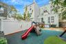 View of jungle gym with a patio area and a fenced backyard