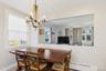 Dining room featuring a baseboard heating unit and a chandelier