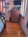 Bedroom with a baseboard radiator and light wood-style flooring