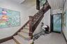 Grand staircase featuring ornate dark wood newel posts and railings