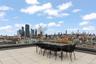 View of patio with a view of skyline and outdoor dining area