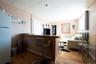 Living room with light hardwood / wood-style flooring and a paneled ceiling